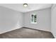 This bedroom features neutral paint, carpet flooring, a window, and closet for comfortable and functional living at 3181 Woodbridge Ct, Snellville, GA 30039