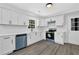 White kitchen features stainless steel appliances, white cabinets and counters at 3181 Woodbridge Ct, Snellville, GA 30039