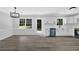 Bright kitchen features white cabinets, stainless steel appliances, and new wood flooring at 3181 Woodbridge Ct, Snellville, GA 30039