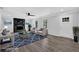 Staged living room with modern flooring, a fireplace, comfortable seating, and stylish decor at 3181 Woodbridge Ct, Snellville, GA 30039