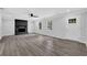 Bright living room showcasing modern flooring, a dark painted fireplace, and natural light at 3181 Woodbridge Ct, Snellville, GA 30039