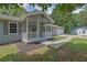 Charming home with covered porch, neat landscaping, and a spacious driveway leading to a two-car garage at 3191 Woodbridge Ct, Snellville, GA 30039