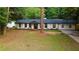 Charming renovated ranch-style home featuring a dark roof, black trim windows, and freshly painted brick at 3790 Village Sw Dr, Atlanta, GA 30331