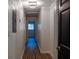 Well-lit hallway features sleek wood-look floors, fresh white walls, and modern light fixture at 3790 Village Sw Dr, Atlanta, GA 30331