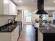 Stylish kitchen featuring ample counter space, a range hood, and seamless integration with dining areas at 3790 Village Sw Dr, Atlanta, GA 30331