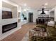A well-lit open-concept living room boasts modern finishes, a sleek fireplace, and a stylish wet bar at 3790 Village Sw Dr, Atlanta, GA 30331