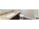 Bathroom featuring granite counters, a white sink, dark wood cabinets, and a toilet at 382 Mulberry Se Row, Atlanta, GA 30354