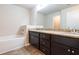 A bathroom featuring granite counters, a white sink, dark wood cabinets, and a tub at 382 Mulberry Se Row, Atlanta, GA 30354