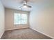 A cozy bedroom features neutral walls, plush carpet, ceiling fan, and a window with natural light at 382 Mulberry Se Row, Atlanta, GA 30354
