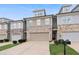 Attractive townhome exterior with two-car garage, featuring brick accents and tidy landscaping at 382 Mulberry Se Row, Atlanta, GA 30354
