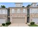 Charming townhome with a two-car garage, brick accents, and neutral siding in a well-maintained community at 382 Mulberry Se Row, Atlanta, GA 30354
