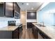 Modern kitchen featuring stainless steel appliances, granite countertops, and dark cabinets at 382 Mulberry Se Row, Atlanta, GA 30354