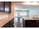 Open-concept kitchen with granite countertops, dark cabinets, and hardwood floors that flow to the living area at 382 Mulberry Se Row, Atlanta, GA 30354