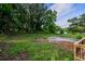 Lush backyard with gravel, framed by mature trees, offers ample space for recreation and relaxation at 5445 Eva Mamie Ln, Stone Mountain, GA 30083