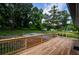 Large backyard with wooden deck and mature trees offers privacy at 5445 Eva Mamie Ln, Stone Mountain, GA 30083