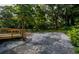 Spacious backyard features a gravel area, deck, and lush greenery, creating a private outdoor oasis at 5445 Eva Mamie Ln, Stone Mountain, GA 30083