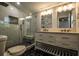 Elegant bathroom featuring glass-enclosed shower, double vanity with quartz countertop and black marble flooring at 5445 Eva Mamie Ln, Stone Mountain, GA 30083