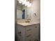 Bright bathroom features a white vanity with tan countertop and a large mirror at 5445 Eva Mamie Ln, Stone Mountain, GA 30083