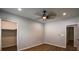 Bedroom with luxury vinyl plank flooring, ceiling fan, a closet, and a freshly painted neutral color at 5445 Eva Mamie Ln, Stone Mountain, GA 30083