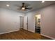 Neutral bedroom with ceiling fan, hardwood floors, and ensuite bathroom access at 5445 Eva Mamie Ln, Stone Mountain, GA 30083