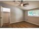 Bedroom with hardwood flooring, closet, ceiling fan and a window at 5445 Eva Mamie Ln, Stone Mountain, GA 30083