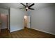 Bedroom featuring wood flooring, ceiling fan, and access to an ensuite bathroom at 5445 Eva Mamie Ln, Stone Mountain, GA 30083
