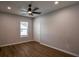 Cozy bedroom with modern ceiling fan, new window, and luxury vinyl plank flooring at 5445 Eva Mamie Ln, Stone Mountain, GA 30083