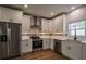 Modern kitchen featuring stainless steel appliances, sleek cabinetry, and hardwood floors at 5445 Eva Mamie Ln, Stone Mountain, GA 30083