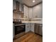 Modern kitchen featuring stainless steel appliances, sleek cabinetry, and hardwood floors at 5445 Eva Mamie Ln, Stone Mountain, GA 30083