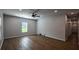 Open-concept living room with a ceiling fan, new windows, luxury vinyl plank flooring and views to the hallway at 5445 Eva Mamie Ln, Stone Mountain, GA 30083