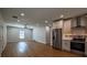 Open-concept living room boasts modern finishes, recessed lighting and a view into the spacious kitchen with stainless steel appliances at 5445 Eva Mamie Ln, Stone Mountain, GA 30083