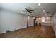 Spacious living room with luxury vinyl plank flooring and recessed lighting open to modern kitchen with gray cabinetry at 5445 Eva Mamie Ln, Stone Mountain, GA 30083