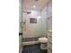 Modern shower features glass door, rainfall shower head, and tiled walls and floor at 5445 Eva Mamie Ln, Stone Mountain, GA 30083