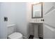 Half bathroom with pedestal sink, white fixtures, and wood-look floors at 626 Skytop Dr # 159, Cumming, GA 30040