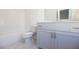 Bathroom featuring a tub, toilet, and large vanity with white and grey color scheme at 626 Skytop Dr # 159, Cumming, GA 30040