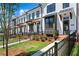 Elegant townhomes showing white facade, modern design elements, and inviting landscaping, creating a warm neighborhood feel at 626 Skytop Dr # 159, Cumming, GA 30040