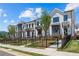 Charming townhomes featuring white exteriors, dark window frames, and well-maintained landscaping for curb appeal at 626 Skytop Dr # 159, Cumming, GA 30040