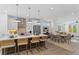 Modern kitchen featuring an island with bar seating, stainless appliances, and an open layout into dining and living areas at 626 Skytop Dr # 159, Cumming, GA 30040
