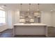 Modern kitchen island with stainless steel pendant lights and sink at 626 Skytop Dr # 159, Cumming, GA 30040