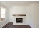 Living room with white brick fireplace, wooden mantle and large window at 626 Skytop Dr # 159, Cumming, GA 30040