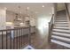 Open-concept living area with stairs and kitchen featuring stainless steel appliances at 626 Skytop Dr # 159, Cumming, GA 30040