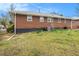 Exterior view of the backyard with a well-maintained lawn, mature trees, and a brick home at 965 Laurel St, Morrow, GA 30260