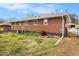 Exterior view of the backyard with a well-maintained lawn and brick home at 965 Laurel St, Morrow, GA 30260