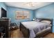 Bedroom featuring a large window with natural light, ceiling fan, and blue painted walls at 965 Laurel St, Morrow, GA 30260