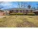 Quaint brick ranch featuring an open carport and established shrubs at 965 Laurel St, Morrow, GA 30260