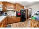 Traditional kitchen with wood cabinets and black appliances at 965 Laurel St, Morrow, GA 30260