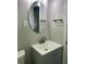 Bathroom vanity with an oval mirror and modern fixtures, creating a stylish space at 2245 Polar Rock Sw Ave, Atlanta, GA 30315