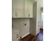 Practical laundry room space with storage cabinets and connections for washer and dryer at 2245 Polar Rock Sw Ave, Atlanta, GA 30315
