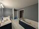 Bathroom showcasing dual vanity sinks, a tub and a tiled shower stall at 446 Westbrook Rd, Carrollton, GA 30116