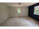 Bright bedroom with two windows and a modern accent wall at 446 Westbrook Rd, Carrollton, GA 30116